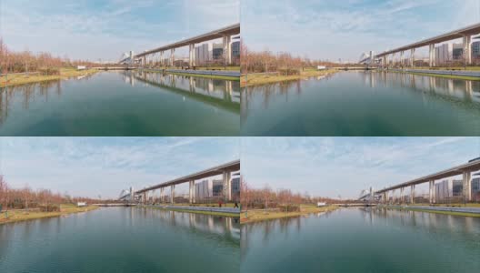 现代大桥及其在湖中的倒影，飘动的云朵，水面上随风荡漾的涟漪，延时镜头，4k视频b卷镜头。高清在线视频素材下载