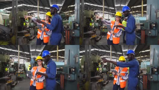 穿着防护服的专业技术人员和工程师小组在工业厂房内工作。把平板电脑拿在手里看看机器是如何工作的。高清在线视频素材下载