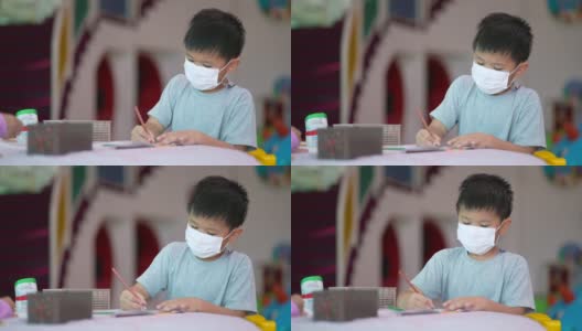 亚洲男孩在学校的美术课上画画高清在线视频素材下载