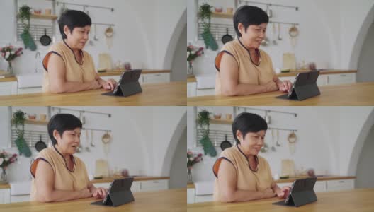 亚洲资深女性使用数码平板电脑进行视频通话高清在线视频素材下载