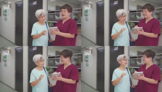 亚裔中国女护士在诊所用数码平板电脑向她的女病人解释体检报告高清在线视频素材下载