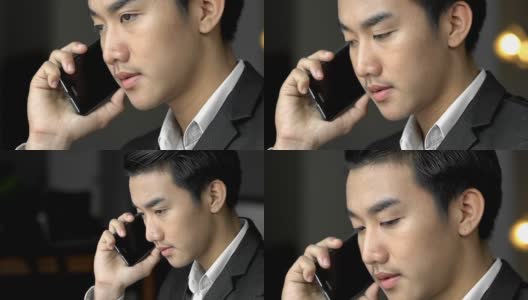 年轻的亚洲泰国商人在移动电话在咖啡馆工作高清在线视频素材下载