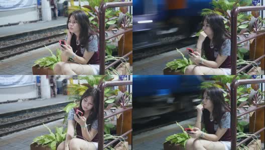 女孩在等火车的时候用手机高清在线视频素材下载