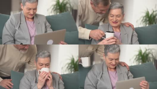 一头灰色短发的成熟女人坐在家里的沙发上用笔记本电脑工作。一位留着灰胡子的男人小心翼翼地给她端来一杯茶。幸福的家庭两者高清在线视频素材下载