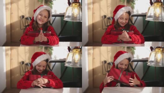 小女孩高兴地打开圣诞礼物高清在线视频素材下载