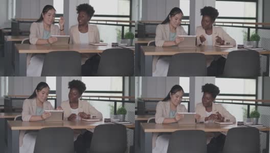 两位女商人在数码平板电脑上查看数据高清在线视频素材下载