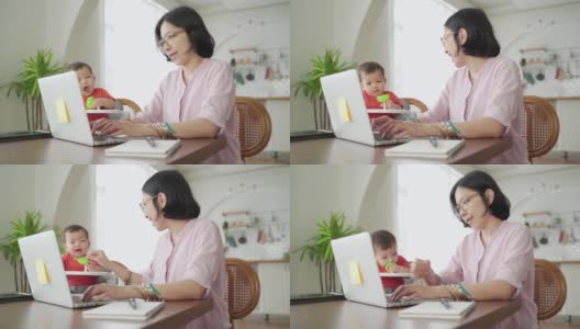 快乐的亚洲母亲母亲自由职业者工作和玩她的儿子在一起高清在线视频素材下载
