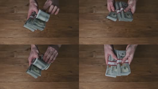 男性的手在木制背景上翻转10000美元的钞票，慢动作高清在线视频素材下载