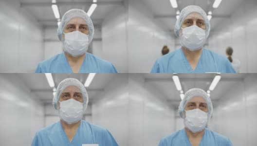 年老的白人男性外科医生走在医院走廊上，在长时间的手术后感到筋疲力尽高清在线视频素材下载
