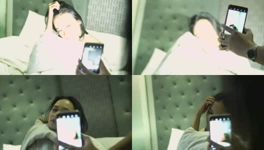 亚洲女性用带闪光灯的智能手机给她最好的朋友拍照高清在线视频素材下载