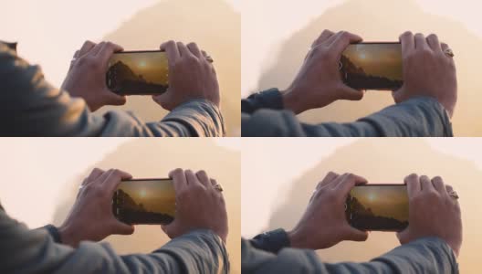 男性的手用智能手机和点击Girnar山的照片的特写。摄影师创造多媒体内容的山在日出，男子点击图片在徒步冒险。高清在线视频素材下载
