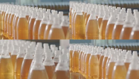 在现代饮料厂，带着瓶装果汁或水的传送带。现代生产的甜苏打水高清在线视频素材下载