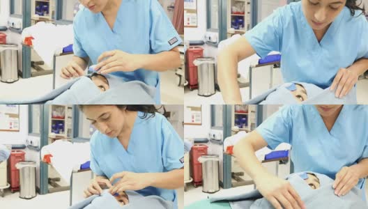 中年西班牙护士准备年轻的亚洲妇女手术高清在线视频素材下载
