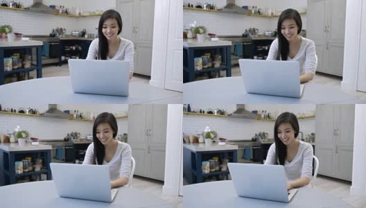 Woman working from home very happy on her laptop美丽的亚洲女人在家工作非常开心在她的笔记本电脑上高清在线视频素材下载