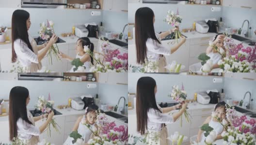 亚洲华人女性花商和女儿插花。每天早上经营小生意的例行公事和家庭团聚的时间高清在线视频素材下载