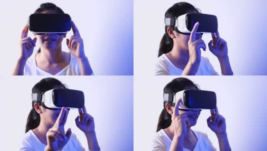 年轻女子在Metaverse体验VR时使用虚拟现实耳机触摸空气。VR(虚拟现实)，技术，视频游戏和元世界概念。高清在线视频素材下载