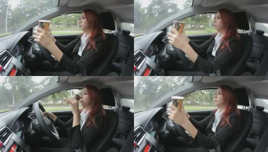 女商人一边开车一边喝咖啡高清在线视频素材下载