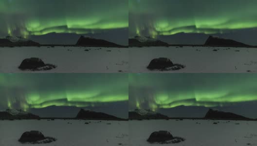 冰冻的北极峡湾上空的北极光-太阳风暴高清在线视频素材下载