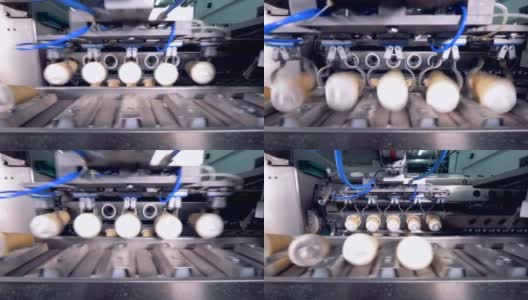自动金属钳子正在把成批的华夫饼冰淇淋放到传送带上高清在线视频素材下载