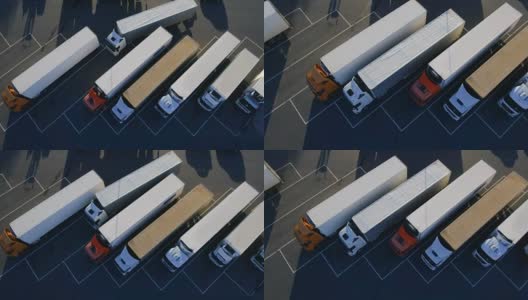 空中鸟瞰图的白色半挂车与其他卡车的货物拖车停车场在特殊停车场。高清在线视频素材下载
