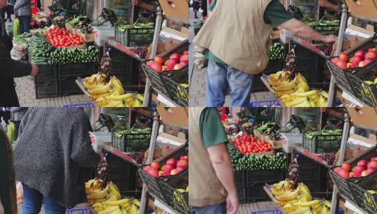 市场柜台上有很多新鲜蔬菜。买家会挑选新鲜的西红柿、土豆、辣椒、豆子、樱桃、香蕉。市场上的买方和卖方。人们选择食品高清在线视频素材下载