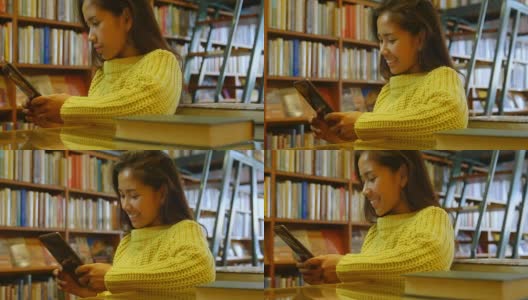 少女使用数字平板在图书馆4k高清在线视频素材下载