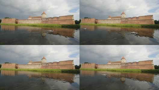 法加拉城堡和戏剧性的天空倒映在周围的水中高清在线视频素材下载