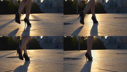 跟随女性的腿高跟鞋走在城市街道在日落时间。穿着高跟鞋的女商人的脚在城市里走动。女孩走着去上班。慢动作关闭侧视图高清在线视频素材下载
