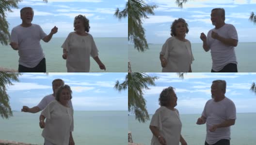 浪漫的亚洲老年情侣在海滩上跳舞高清在线视频素材下载