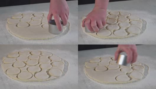 一名妇女用圆形模具把生面团切成圆圈，用来做小圆面包、甜甜圈。高清在线视频素材下载