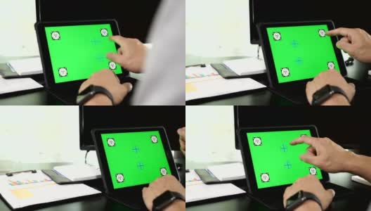 一名亚洲男子使用绿色空白屏幕的平板电脑高清在线视频素材下载