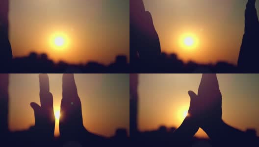 夕阳下的城市剪影，双手合拍的慢镜头高清在线视频素材下载