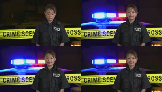 亚裔美国女警官对着镜头微笑，背景是犯罪现场高清在线视频素材下载