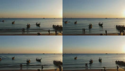 夕阳西下的奥南海滩上的长尾船高清在线视频素材下载