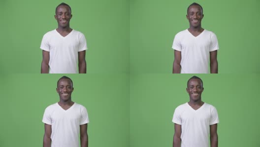 年轻快乐的非洲人在绿色的背景下微笑高清在线视频素材下载