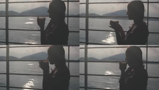 年轻女孩沉思地坐在货运渡轮的长椅上，用纸杯喝着咖啡，望着大海。1920 x1080高清在线视频素材下载