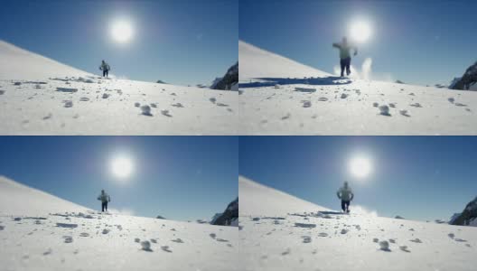 慢镜头拍摄的人走在雪山环境在阳光明媚的一天高清在线视频素材下载