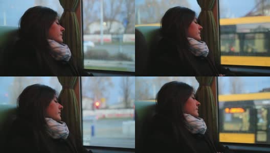 一段女乘客在公交车上睡觉的视频。乘客女孩睡在移动的公交车上高清在线视频素材下载