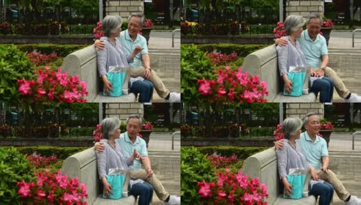 一对老年夫妇在公园长椅上放松聊天高清在线视频素材下载