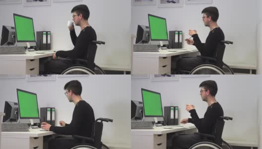 坐着轮椅的办公室职员，深色头发的女人在电脑旁边的工作场所喝咖啡，慢镜头高清在线视频素材下载