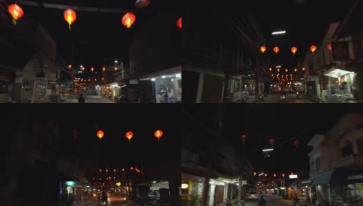 晚上骑在装饰着中国灯笼的街道上高清在线视频素材下载