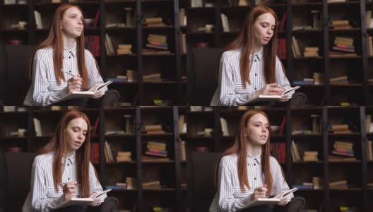 肖像迷人的红发年轻女子记者采访人在舒适的黑暗的房间。高清在线视频素材下载