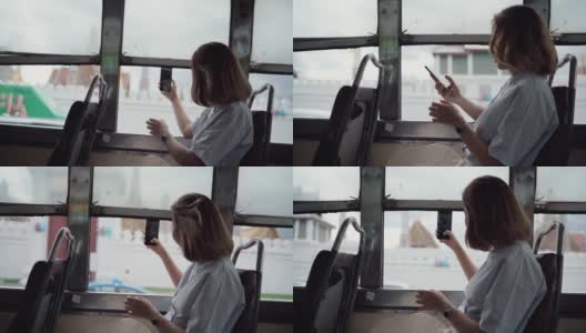 美女在公交车上用智能手机拍照高清在线视频素材下载