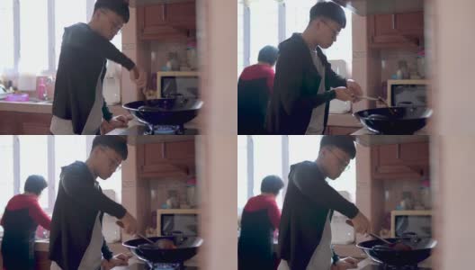 亚洲华人少年在厨房做饭，准备年夜饭高清在线视频素材下载