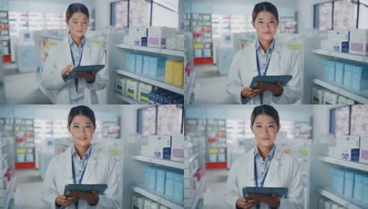 药店:美丽的亚洲药剂师使用数字平板电脑的肖像，看着相机和迷人的微笑，在她摆满药包的货架后面。中等的特写镜头高清在线视频素材下载