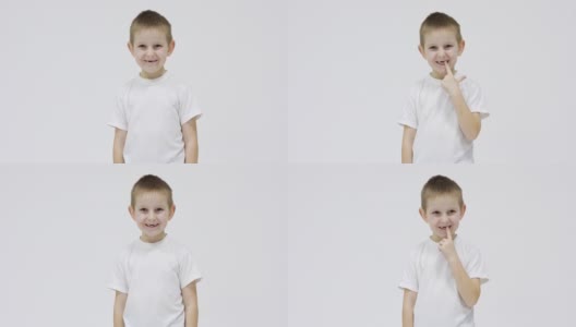 身穿白色t恤的快乐小男孩张开嘴，在白色背景上展示他的乳牙掉在哪里高清在线视频素材下载