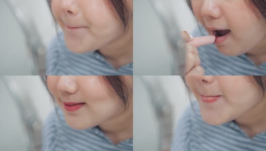 亚洲女人在镜子前涂口红的嘴高清在线视频素材下载