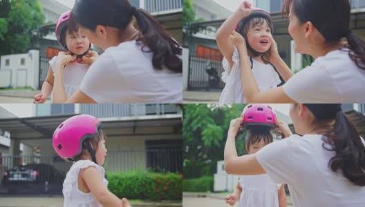 亚洲妈妈早上在街上骑自行车锻炼，给可爱的小女儿戴上运动头盔。快乐的少女戴上防护头盔，以保健康、保安全高清在线视频素材下载