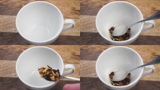 木桌上的白色杯子里放着一茶匙的干果花茶高清在线视频素材下载