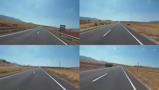 在西班牙，骑摩托车的人在风景优美的沙漠和空旷的道路上。第一个人的观点高清在线视频素材下载